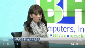 Employee standing in front of Computer Recycling Service logo